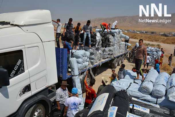 Workers unload trucks laden with hundreds of tents for families displaced by the recent fighting in Iraq. Photo: UNHCR/E. Colt