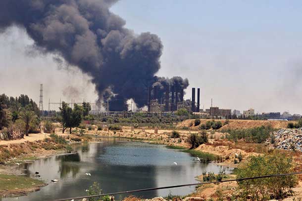 Smoke and flames rise from Gaza's electricity distribution company plant after it was hit by Israeli strikes in the Nusseirat refugee camp, central Gaza Strip. UN Photo/Shareef Sarhan