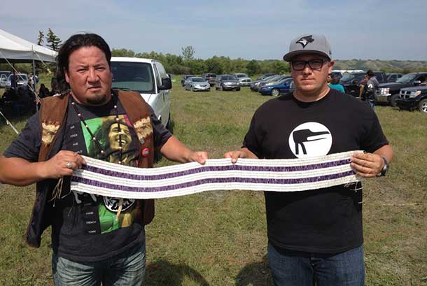 Assembly of Manitoba Chiefs Grand Chief Derek Nepinak with Ryan McMahon and the Two Row Wampum Belt