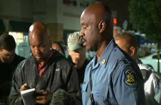 Patrol Capt. Ron Johnson talking to reporters and members of the public