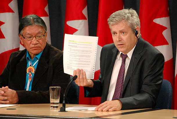Charlie Angus with Edmund Metatawabin holding up the false evidence narrative supplied by the Justice Department for the IAP hearings.