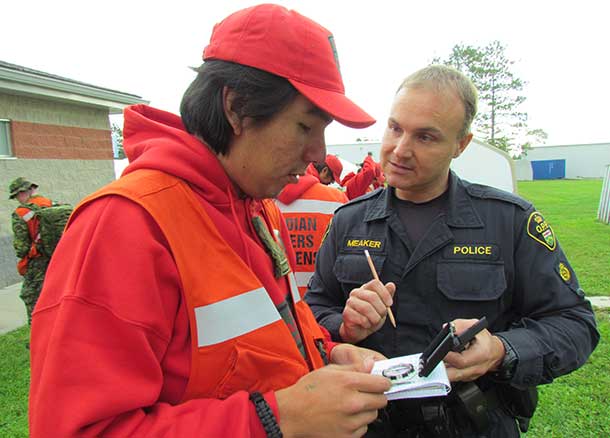 OPP Constable John Meaker reviews the use of a compass with Ranger Sinclair Childforever of Fort Severn