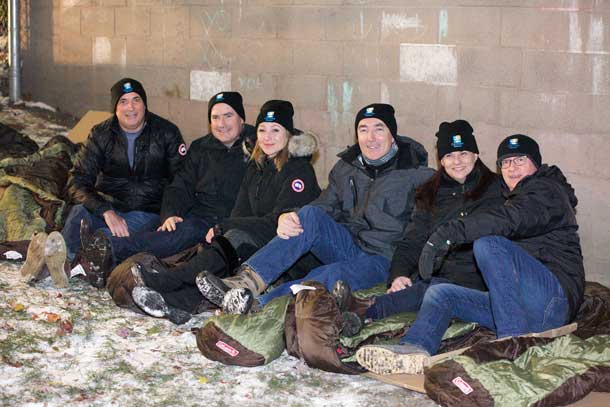 Bedding down for homeless youth at Covenant House Toronto's Executive Sleep Out are (l to r) Duncan Hannay, president, Davis & Henderson Ltd., Cineplex Entertainment COO Dan McGrath, The Stronach Group Chairman and President Belinda Stronach, Purolator President Patrick Nangle, TAXI Canada President Nancy Beattie, and Covenant House's Bruce Rivers.
