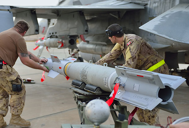 Kuwait – Royal Canadian Air Force ground crew align a bomb as they mount munitions on a CF-188 Fighter jet prior to the first combat mission over Iraq in support of Operation IMPACT. (Photo IS2014-5022-07 by Canadian Forces Combat Camera)