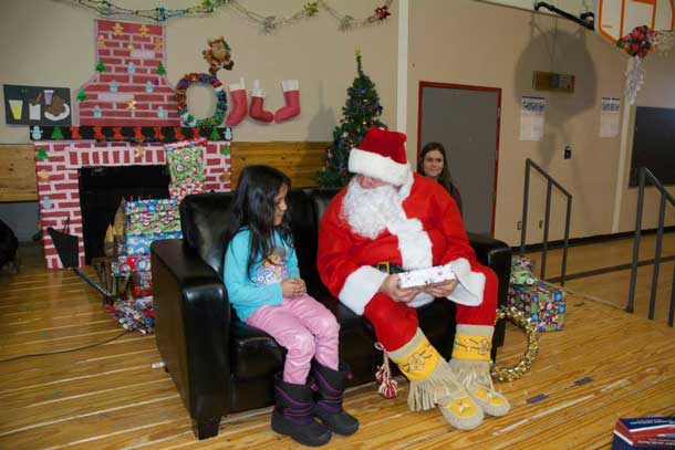 Santa taking the time to share with the kids in Ogoki