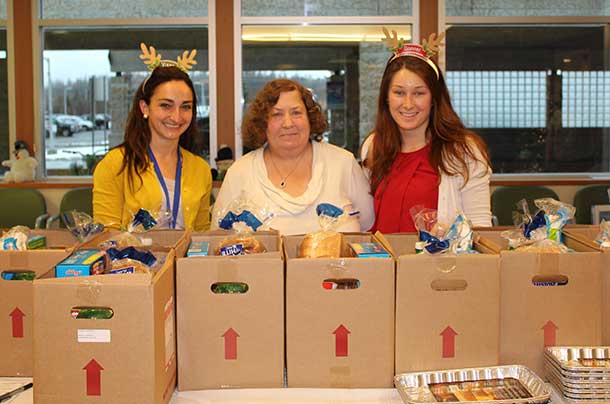 Renal patient, Debbie Sohlman (middle), picks up her specially-made Christmas hamper for renal dialysis patients from Thunder Bay Regional Health Sciences Centre’s Renal Services Registered Dietitians, Michelle Lawrence (left) and Holly Freill (right).
