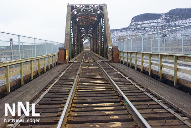 Chain Link Fence on the sides of the CN Rail James Street Bridge allow pedestrian traffic.