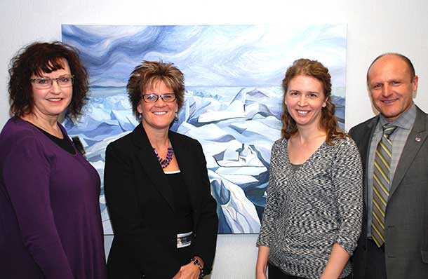 The Travelling Painting, at home at Investors Group in January, with (l-r) Laura Fralick, owner of the painting, Donna Yocom, Regional Director of Investors Group Financial Services Inc., Colleen Rose, artist of the painting, and Dan Bissonnette, Health Sciences Foundation. This month it is at Shout Media, then on to Lisa Sandham Interior Design for the month of March.