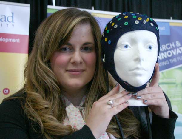Lakehead Psychology student Dana Dupuis holds an EEG cap that will be on display at the Intercity Shopping Centre on Saturday