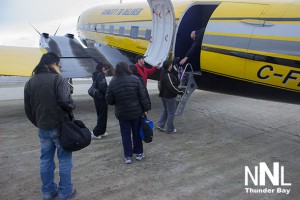 Passengers embark on First Cargo North Charter passenger service on the Basler