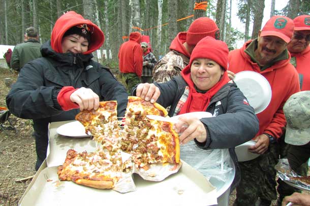 Ranger Nicole Gillies and her sister, Bernadette Gillies, both of Fort Albany, enjoy some of the pizza that arrived on a supply plane during the water rescue training