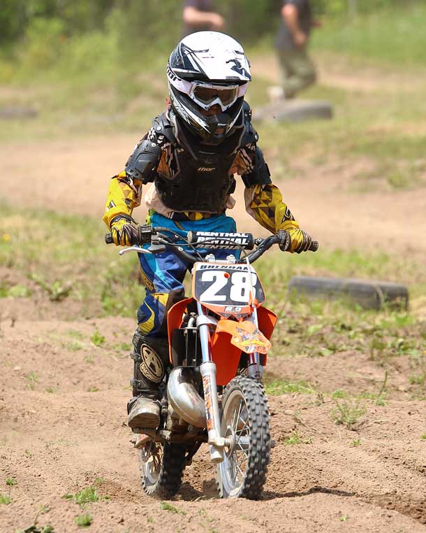 Brendan Moreau (28) races through the “whoops” section of the track in the 50 cc class - Photo by Guy Gascoigne