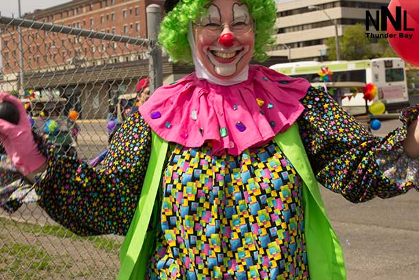 Clowns reaching out to enjoy the Thunder Pride Parade