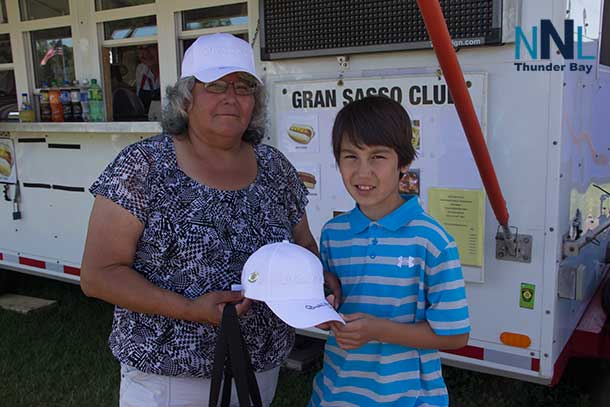 This young fan and his mom were sharing time together and show off their autographed ball caps