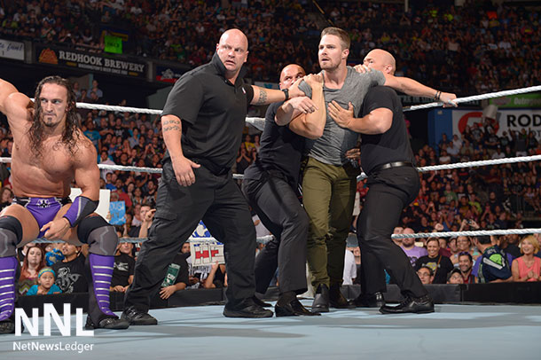 WWE® Security restrains Red Arrow Star Stephen Amell after brawl with Stardust