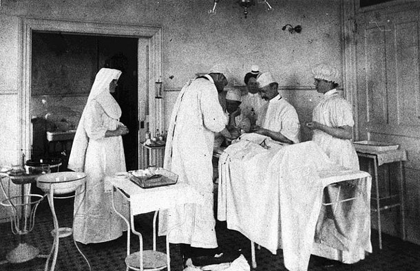 The above photo depicts surgery at St. Joseph’s Hospital in 1906, and is an example of what can be seen at the exhibit. From left to right: Sister Lagourie, E. Regan, Dr. McGrady, Dr. Brown, Dr. Pratt, and Miss N. York (student nurse)