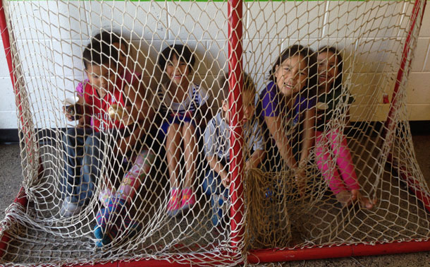Hockey nets and the imagination of young people can mean anything - Here the youth are behind the spiderweb