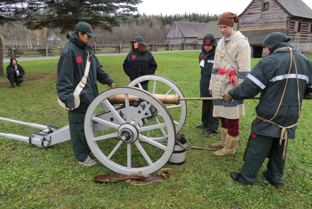 Junior Canadian Rangers prepare a canon for firing at Fort William Historical Park