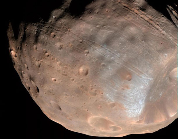 New modeling indicates that the grooves on Mars' moon Phobos could be produced by tidal forces -- the mutual gravitational pull of the planet and the moon. Initially, scientists had thought the grooves were created by the massive impact that made Stickney crater (lower right).
