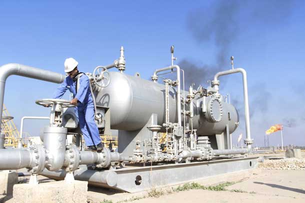 A worker checks the valve of an oil pipe at Nahr Bin Umar oil field, north of Basra, Iraq December 21, 2015. REUTERS/Essam Al-Sudani