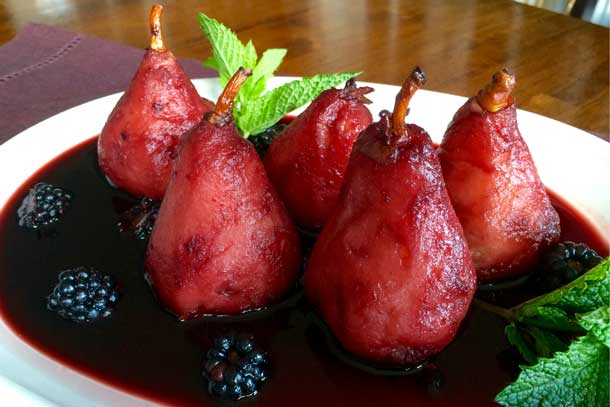 Prepare festive fruits for your holiday table, such as wine poached pears with blackberries. Credit: Copyright 2015 P.K. Newby