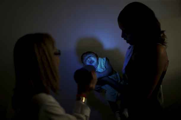 Daniele Ferreira holds her son Juan Pedro during a session to stimulate the development of his eyesight at the Altino Ventura rehabilitation center in Recife, Brazil, January 28, 2016. REUTERS/Ueslei Marcelino