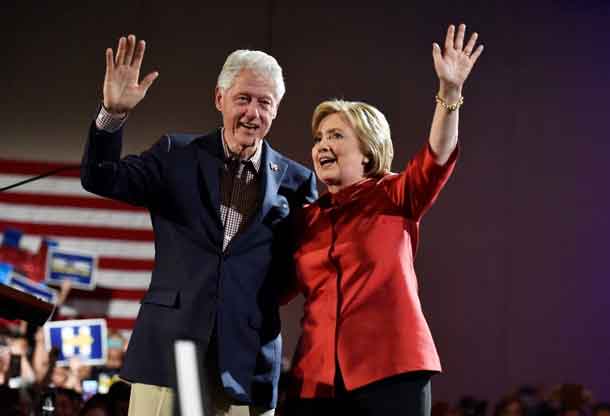 Hillary Clinton and her husband former President Bill Clinton wave to supporters after she was projected to be the winner in the Democratic caucuses  in Las Vegas. REUTERS/David Becker
