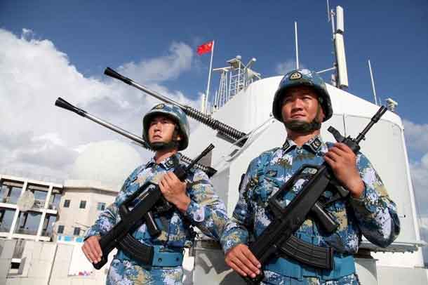 Soldiers of China's People's Liberation Army (PLA) Navy stand guard in the Spratly Islands, known in China as the Nansha Islands, February 10, 2016. REUTERS/Stringer