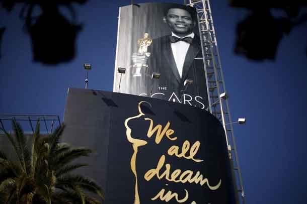 Oscars host Chris Rock is seen on a poster at the entrance to the Dolby Theatre red carpet on Hollywood Boulevard as preparations continue for the 88th Academy Awards in Hollywood, Los Angeles, California February 27, 2016. REUTERS/Lucy Nicholson