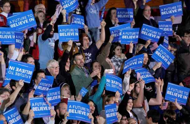 Supporters of Democratic U.S. presidential candidate Bernie Sanders, react as CNN projects a win for Sanders at his 2016 New Hampshire presidential primary night rally in Concord, New Hampshire February 9, 2016. REUTERS/Rick Wilking
