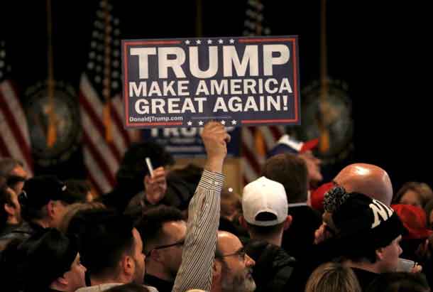 A supporter holds a placard at Republican U.S. presidential candidate Donald Trump's 2016 New Hampshire presidential primary election night rally in Manchester, New Hampshire, February 9, 2016. 2016. REUTERS/Mike Segar .