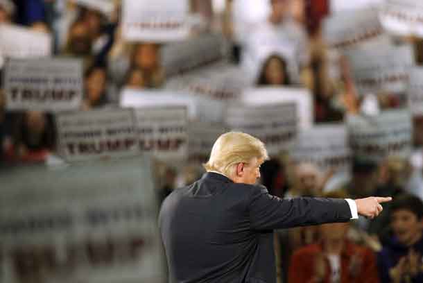 Republican presidential candidate Donald Trump points out a questioner at a campaign rally at the Iowa State Fairgrounds in Des Moines, Iowa, December 11, 2015. REUTERS/Scott Morgan