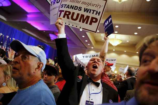 Supporters of U.S. Republican presidential candidate Donald Trump celebrate the close of the polls as they watch election results at a rally in Spartanburg, South Carolina February 20, 2016. REUTERS/Jonathan Ernst