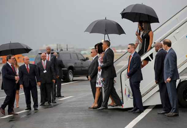 U.S. President Barack Obama and his wife Michelle approach Cuba's foreign minister Bruno Rodriguez (L) as they arrive at Havana's international airport for a three-day trip, in Havana March 20, 2016. REUTERS/Carlos Barria