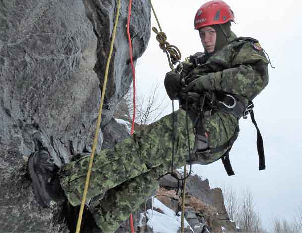 Leading Seaman Christine (Tina) Gillis climbing on a high rock face. credit: Sergeant Peter Moon, Canadian Rangers