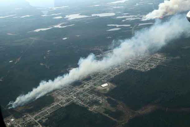 Aerial attack on Nipigon District Fire 14 at the bottom left of the photo stopped the fire as it threatened the western sector of Geraldton. Nipigon District Fire 13 – top right of the photo which threatened the Geraldton airport, the Greenstone Fire Management Headquarters and the Hutchison Lake Subdivision is a combination of fires that merged into one.