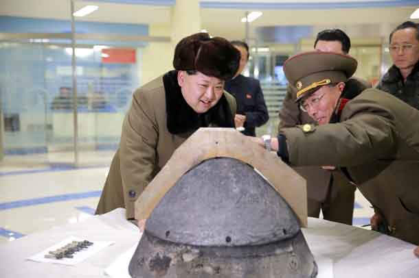 North Korean leader Kim Jong Un looks at a rocket warhead tip after a simulated test of atmospheric re-entry of a ballistic missile, at an unidentified location in this undated photo released by North Korea's Korean Central News Agency (KCNA) in Pyongyang on March 15, 2016. REUTERS/KCNA