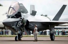 A pilot climbs down from the cockpit of a US Marine Corps Lockheed Martin F-35B fighter jet at the Royal International Air Tattoo at Fairford