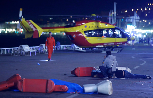 An injured individual is seen on the ground after at least 30 people were killed in Nice, France, when a truck ran into a crowd celebrating the Bastille Day national holiday July 14, 2016. REUTERS/Eric Gaillard