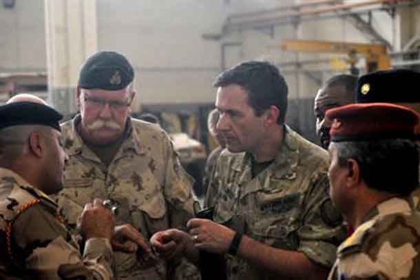 Canadian army Brig. Gen. David Anderson, director of the coalition's ministerial liaison team for Combined Joint Task Force Operation Inherent Resolve, left, and British army Maj. Gen. Doug Chalmers, the coalition's deputy commander of strategy and sustainment, right, speak to the Iraqi leaders of a vehicle maintenance facility during a logistics symposium at Camp Taji, Iraq, July 28, 2016. Army photo by 1st Lt. Daniel Johnson