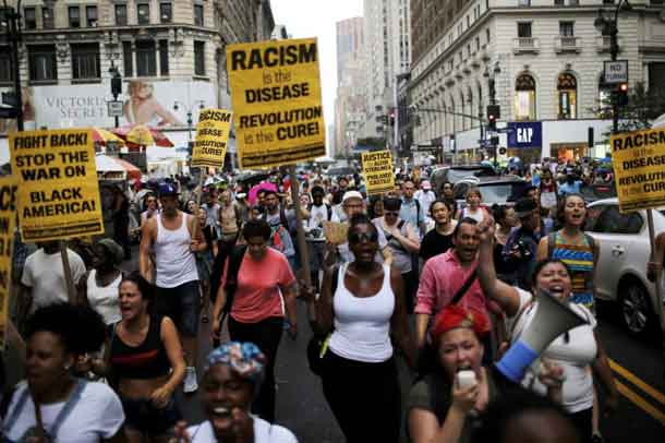 People take part in a protest for the killing of Alton Sterling and Philando Castile during a march along Manhattan's streets in New York July 7, 2016. REUTERS/Eduardo Munoz