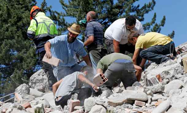 Rescuers work on a collapsed building following an earthquake in Amatrice, central Italy. REUTERS/Ciro De Luca