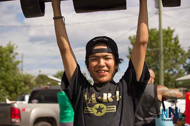 Testing your own strength in the Youth Zone at Thunder Bay's Strongest Man competition. Skylar shows his potential. Photo by Kateri Perreault