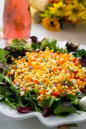 Colorful Corn Salad. This quick stir-fry using fruity extra virgin olive oil, fresh corn kernels, a colorful mix of chopped bell peppers and red onion needs only salt, pepper, cilantro and lemon juice to finish. Serve on a bed of fresh greens. Credit: Copyright 2016 Caroline J. Beck