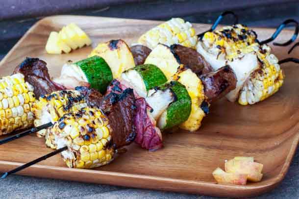 Jerk Lamb Corn and Fruit Kebabs. Jamaican jerk spices rubbed into the lamb add a Caribbean punch to any grilling. The allspice -- key to Jamaican food -- unexpectedly highlights the juicy fruit and sweet corn. Serve with a rum punch. Credit: Copyright 2016 Tami Weiser