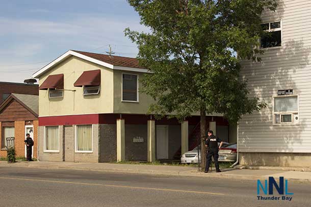 Uniformed Thunder Bay Police Service Officers guarding the perimeter of the building on the 700 block of Simpson Street
