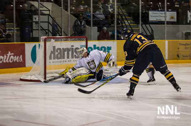 #13 for the Pronghorns, Mitchell Maxwell puts the puck behind Devin Green in the Thunderwolves net