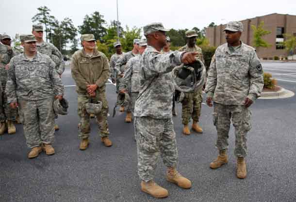 National Guard Staff Sargent Reggie McCall (C) gives instructions to guard units 1782 and 172 before deploying for duty in Conway, South Carolina. REUTERS/Randall Hill