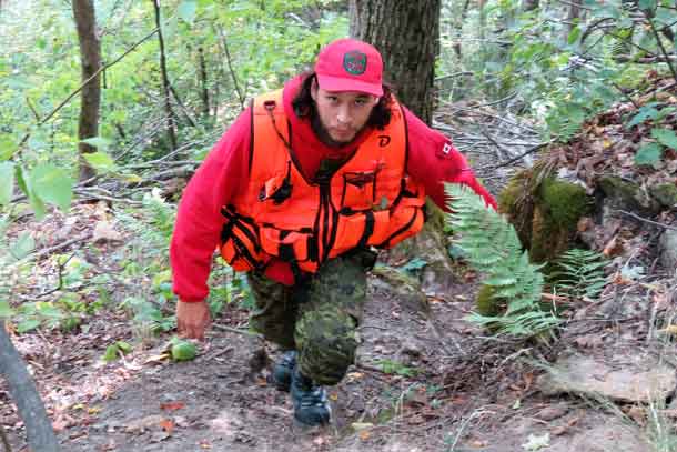 Ranger Kevin Smith nears the top of a 30-metre climb during a search and rescue exercise. credit: Sergeant Peter Moon, Canadian Rangers.