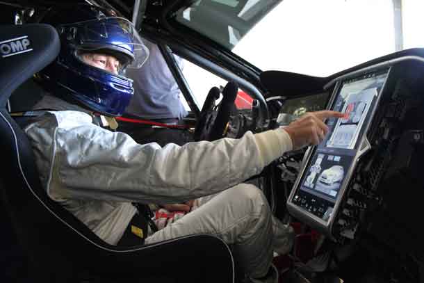 Heinz Harald Frentzen of Germany touching the screen e race version of a Tesla Model S P85+ after Frentzens race tests in Le Castellet, France, on 19-10-2016.